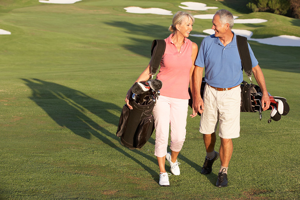 A senior couple enjoying time together on a golf course